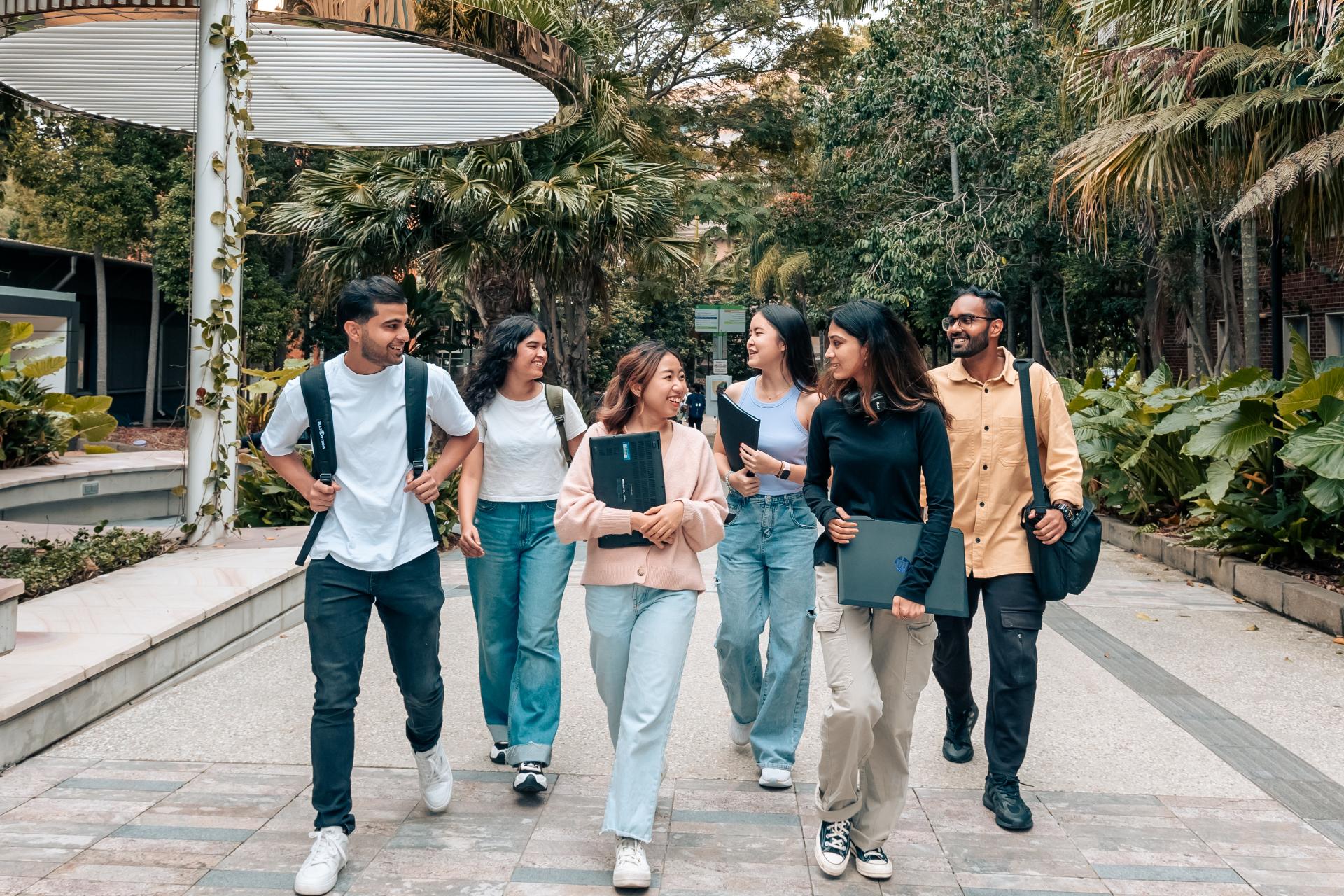 A group of students walking through the University of Queensland campus in Brisbane. 