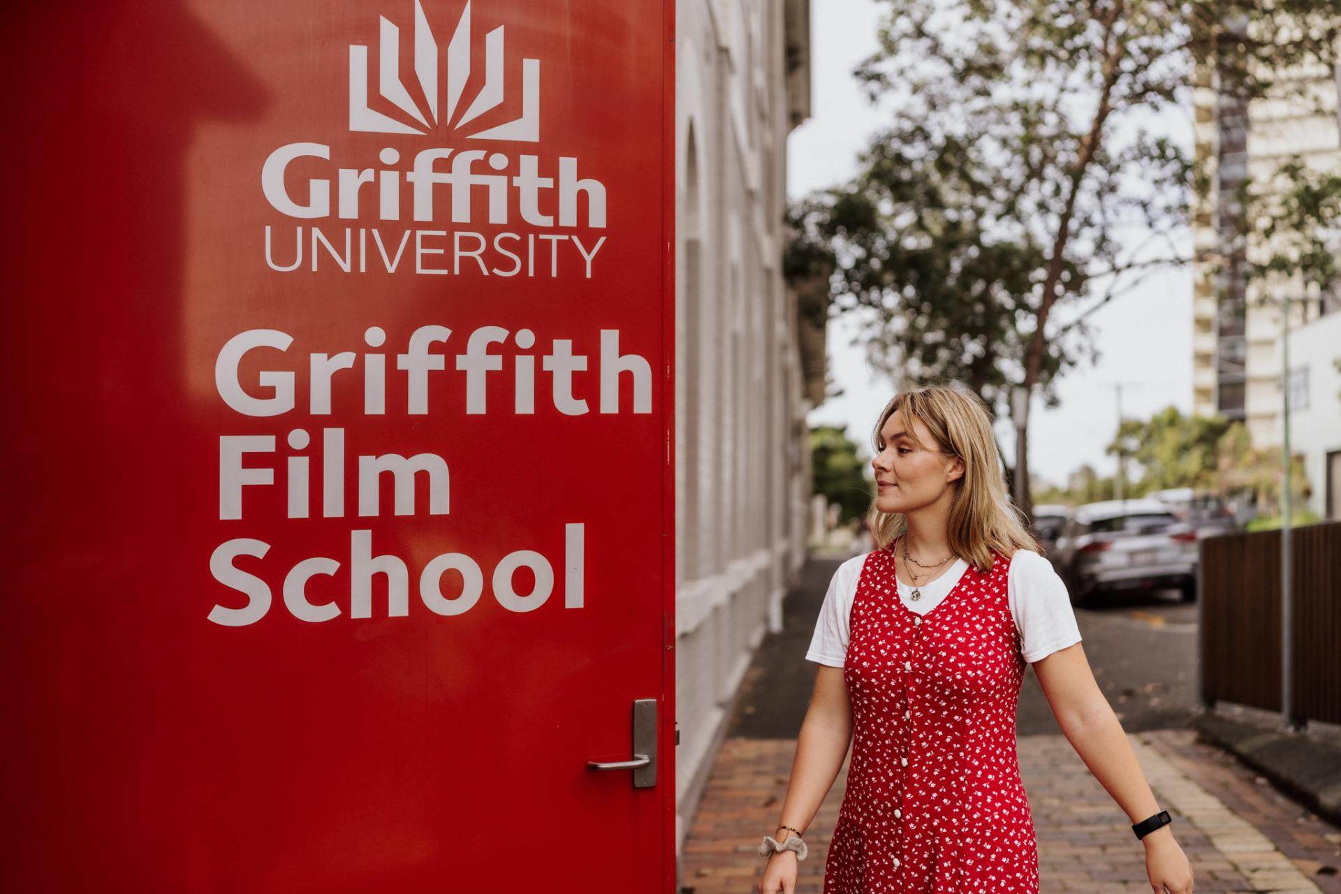 Female Griffith University student walking into campus. 