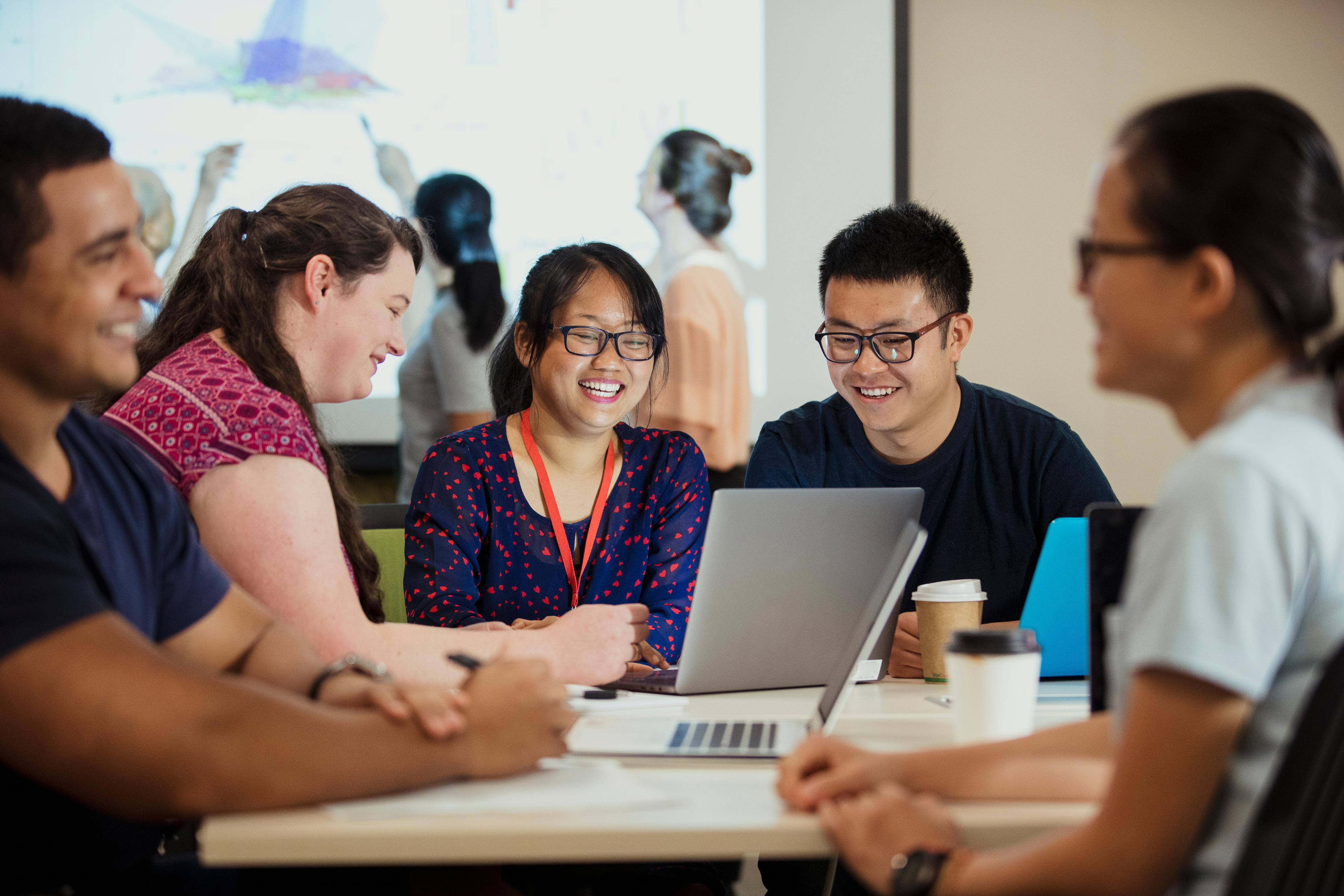 Group of students around a computer. 